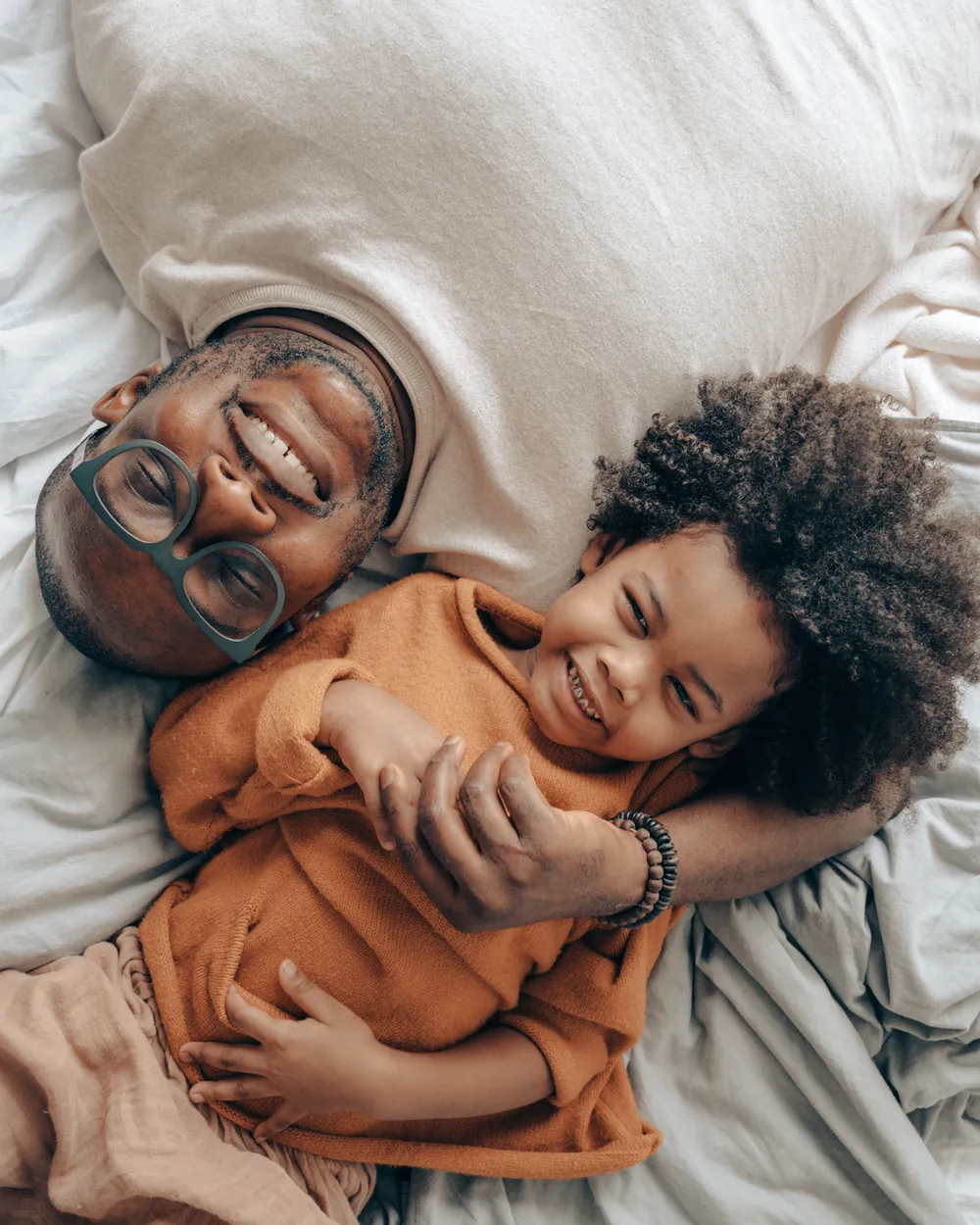 A father and his daughter laughing together at home