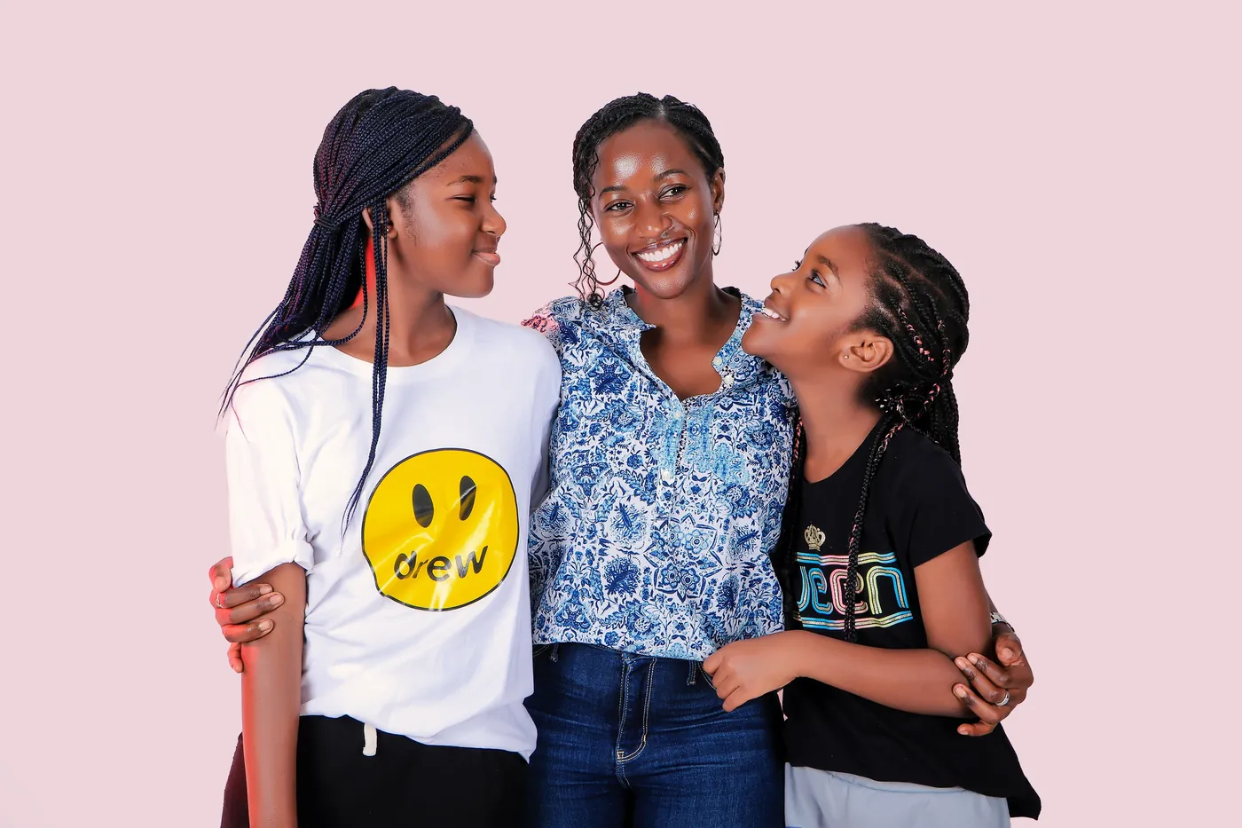 A mother standing with her two daughters